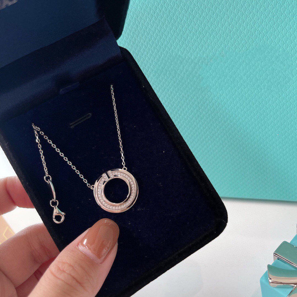 TIFFANY & CO. DIAMOND AND MOTHER OF PEARL CIRCLE PENDANT